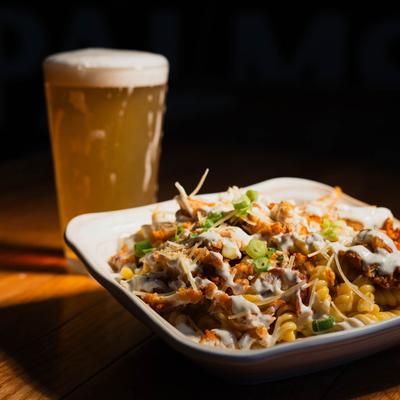 Mac and Cheese with fried chicken, bacon, ranch, scallions, and beer.