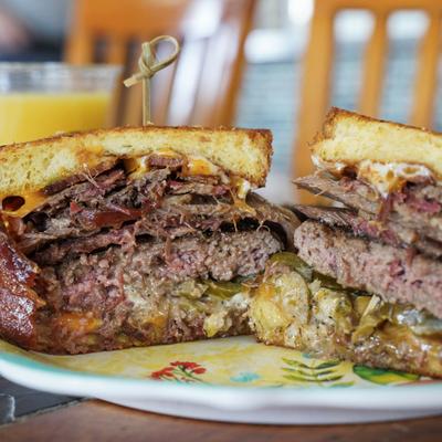 Chez Special burger with grilled cheese, burger patty, smoked beef brisket, and jalapenos.