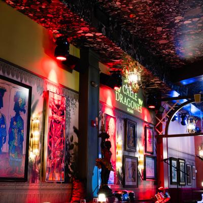 Dining room interior with wall art and neon lighting.