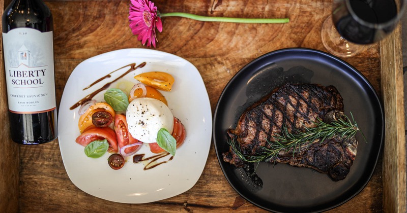 Caprese salad and house steak, served with red wine