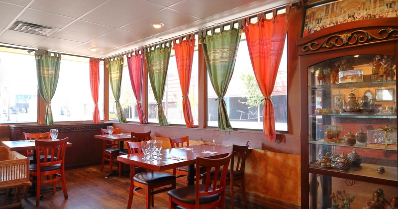 Interior, tables and chairs in dining area with windows
