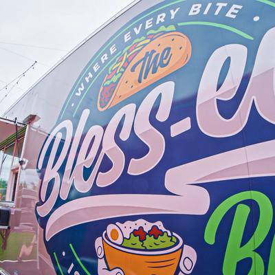 Food truck featuring a vibrant, colorful exterior wrap with signage.