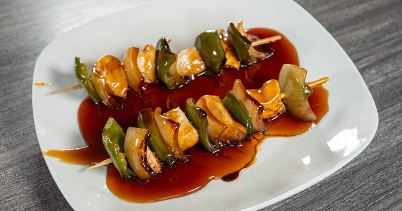 Kabob Chicken skewers served in a sauce