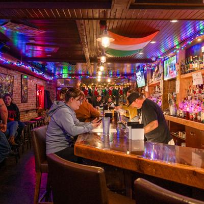 Customers sitting at the bar.