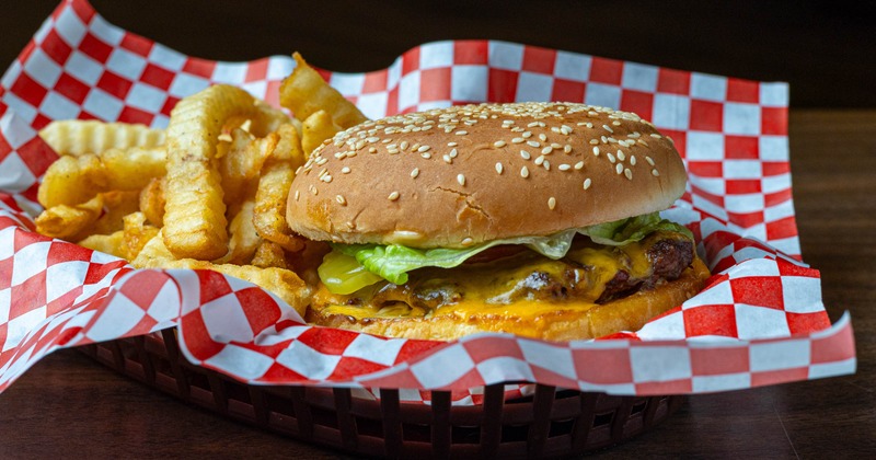 Beef burger served with crinkle-cut fries
