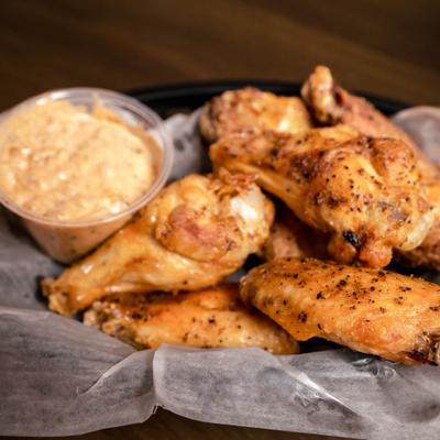 Chicken wings served with dipping sauce.