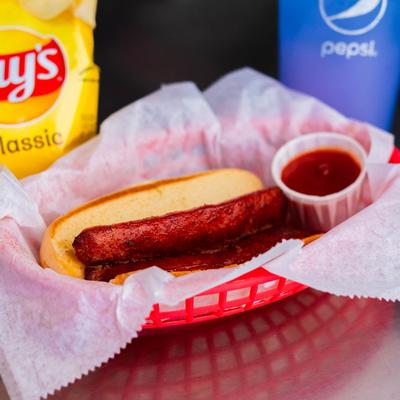 Hot dog with a side of ketchup.