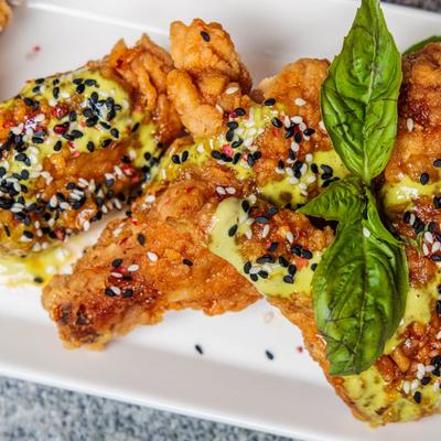Crispy chicken strips with herb garnish.