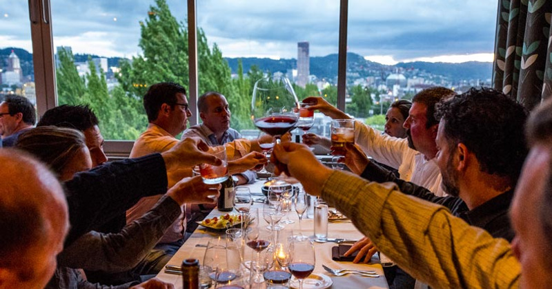 Interior, several guests toasting with wine glasses