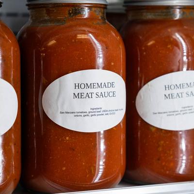 Jars of homemade meat sauce, close up.