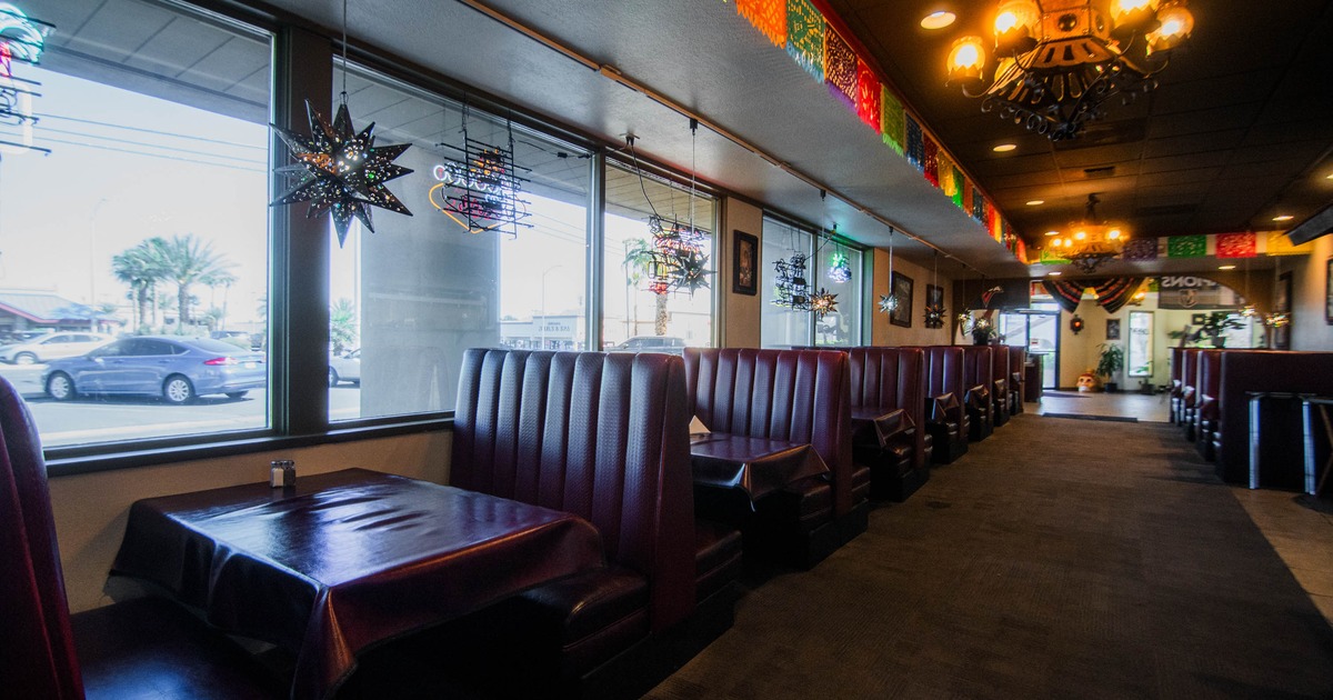 Restaurant interior with red booths, star lights, and colorful paper banners