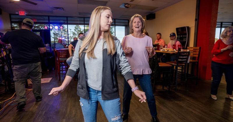 Two people dancing in a restaurant