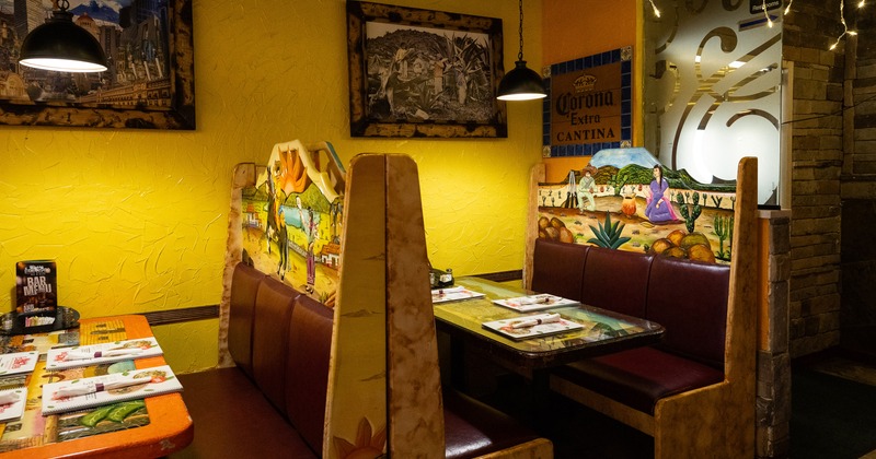 Interior of a Mexican-style restaurant, dining booths with set tables
