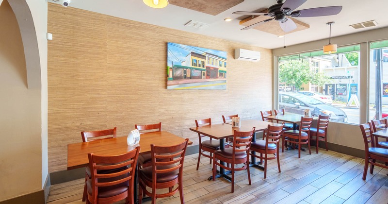 Interior, lined up tables by a window