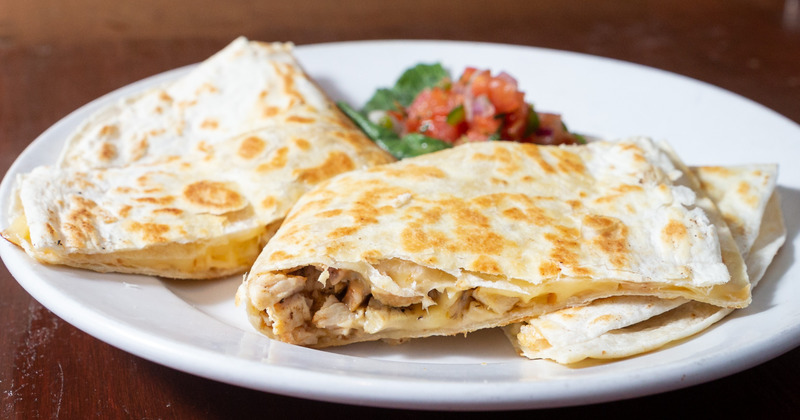 Pastry filled with meat, tomato on the side