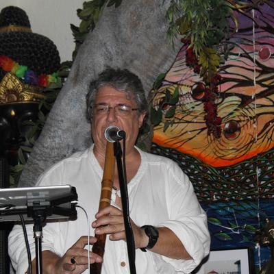 A person playing a wooden cylindrical instrument.