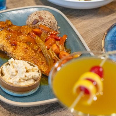 A served cocktail and a meal.