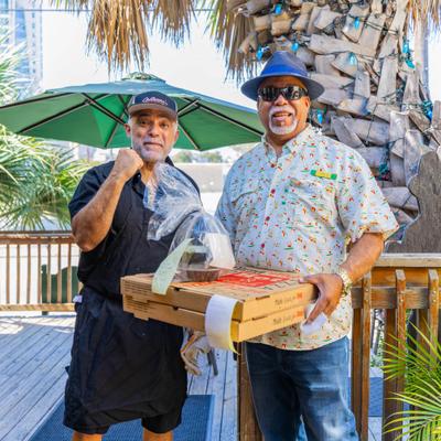 Two person with pizza boxes.