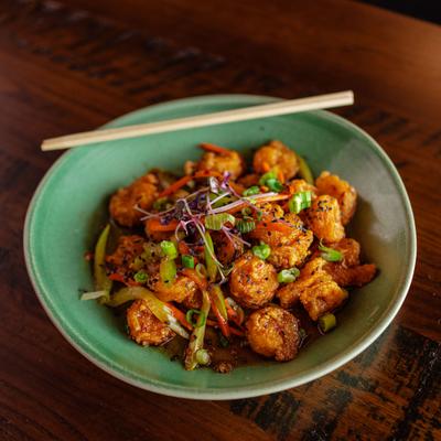 Sweet and spicy fried shrimp with strips of vegetables