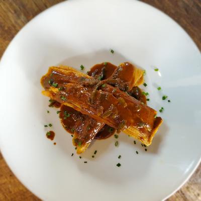 Mississippi Tamale on a white plate available at southern pecan Restaurant gulf coast kitchen