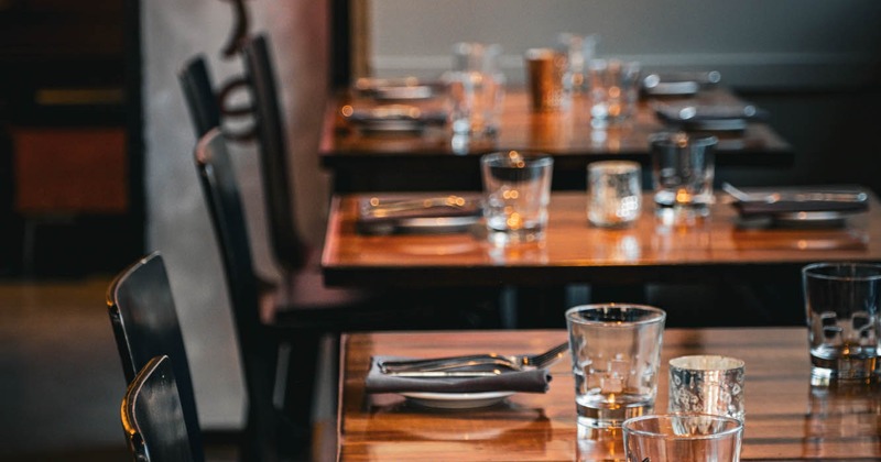 Interior, set tables with tableware and glasses