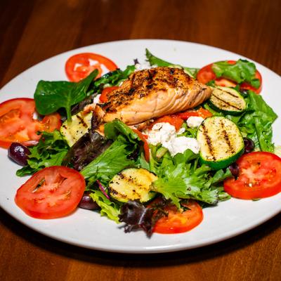 Mixed greens with grilled vegetables, cheeses and grilled salmon.