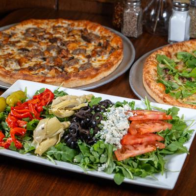 Pollo Italian salad served with pizzas.