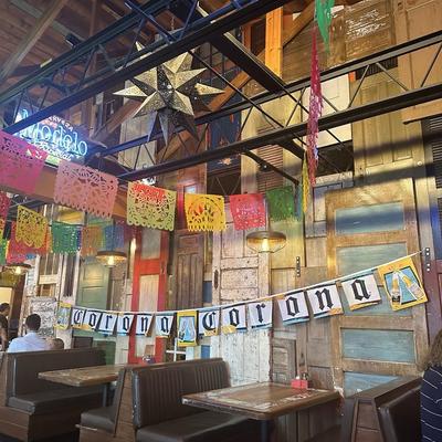 Interior with booths, tables and colorful banners.