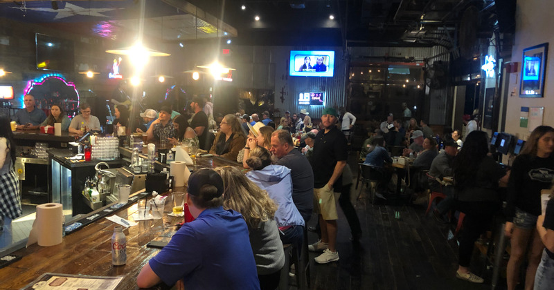 Guests sitting at the bar and main dining area