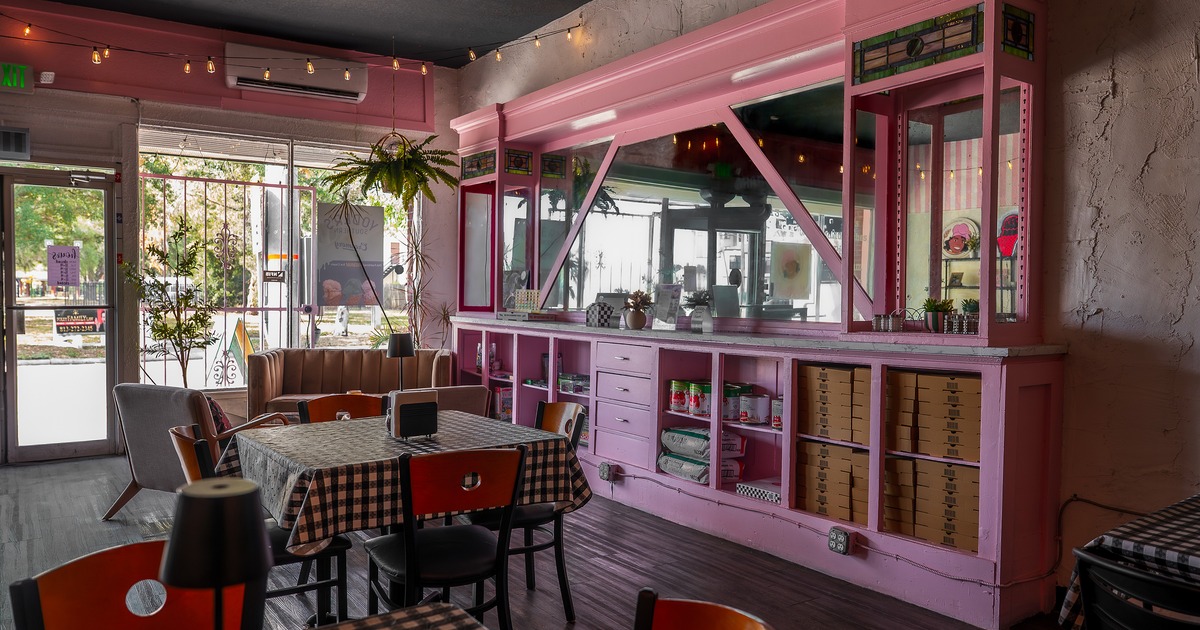 A modern-rustic and cozy interior dining area and pastel pink service counter