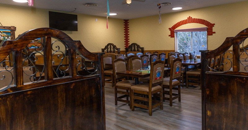 A cozy restaurant dining area with wooden tables and chairs