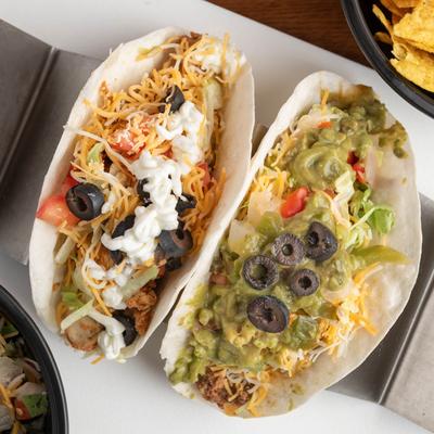 Ground beef and grilled chicken tacos, top view.