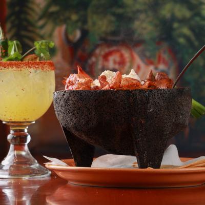 Dish in bowl, cocktail on the side