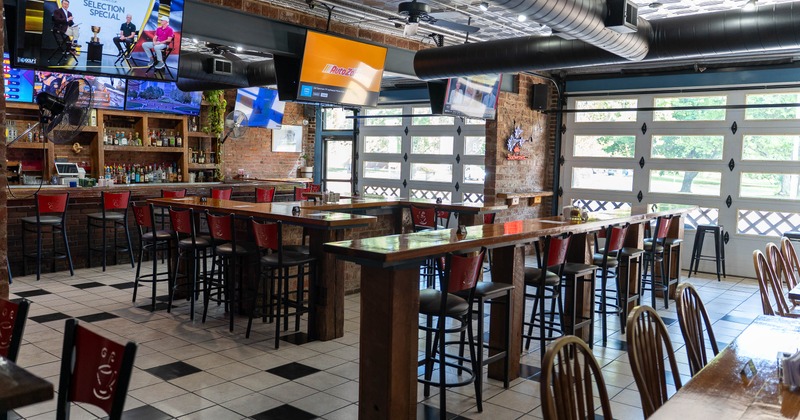 Sports bar with high top tables and multiple TVs