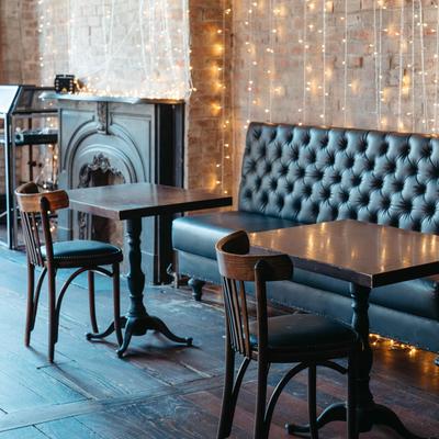 Interior, upholstered seating, tables, a fireplace.