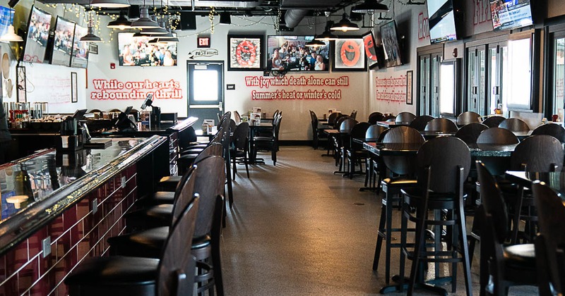 Interior, dining and bar area, high and regular tables, ready for guests, bar on the left
