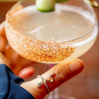 Person holding glass with cocktail