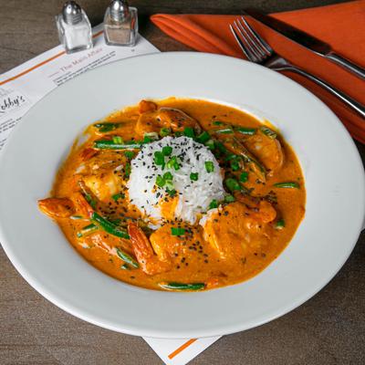 Shrimp curry with rice, green beans, and black sesame seeds.