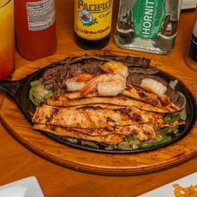 Grilled steak, chicken, and shrimp Fajitas.
