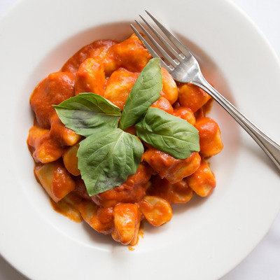 Homemade potato dumplings, with garlic, basil, and tomato sauce.