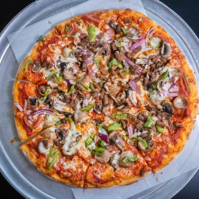 Sausage and pepperoni pizza topped with mushrooms, olives, peppers, and red onions.