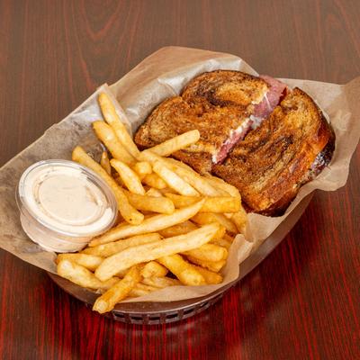 Reuben on rye served with 1000 island dressing and French fries.