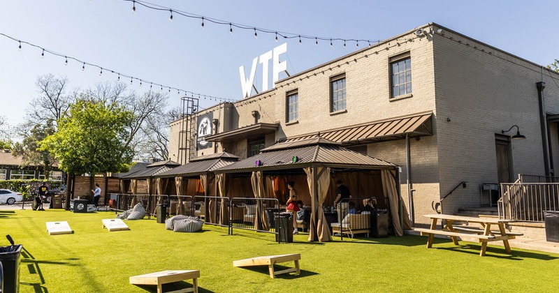 Exterior, covered seating area, cornhole boards