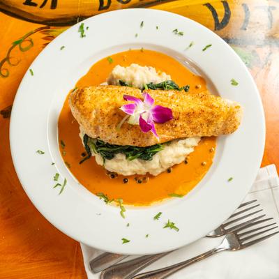 Fried fish fillet, on a bed of mashed potatoes.