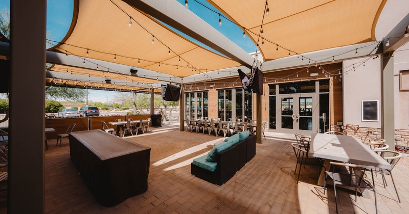 Exterior, large pergola, partially covered area, long community tables with chairs