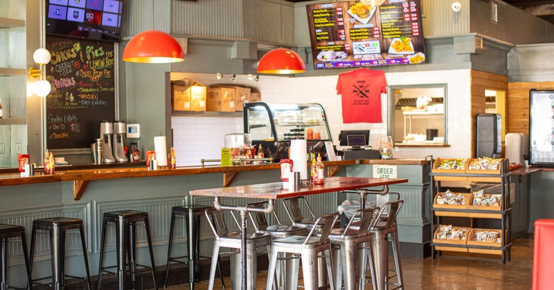 Interior, food counter bar table and chairs in front