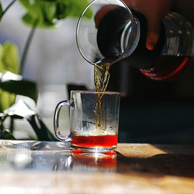 A hand pouring a drink.