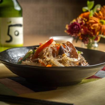 Potato noodles with veggies served on the table.