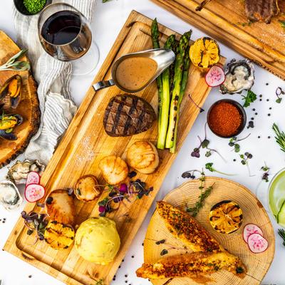 Assorted grilled dishes served on wooden boards