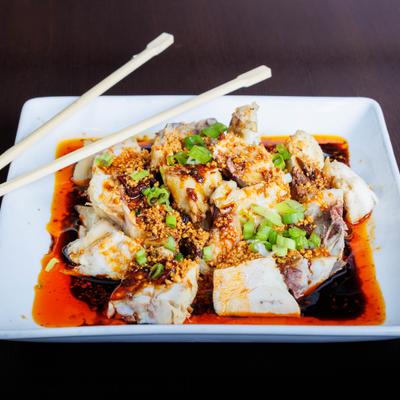 Spicy chili oil chicken with crushed peanuts and scallions.